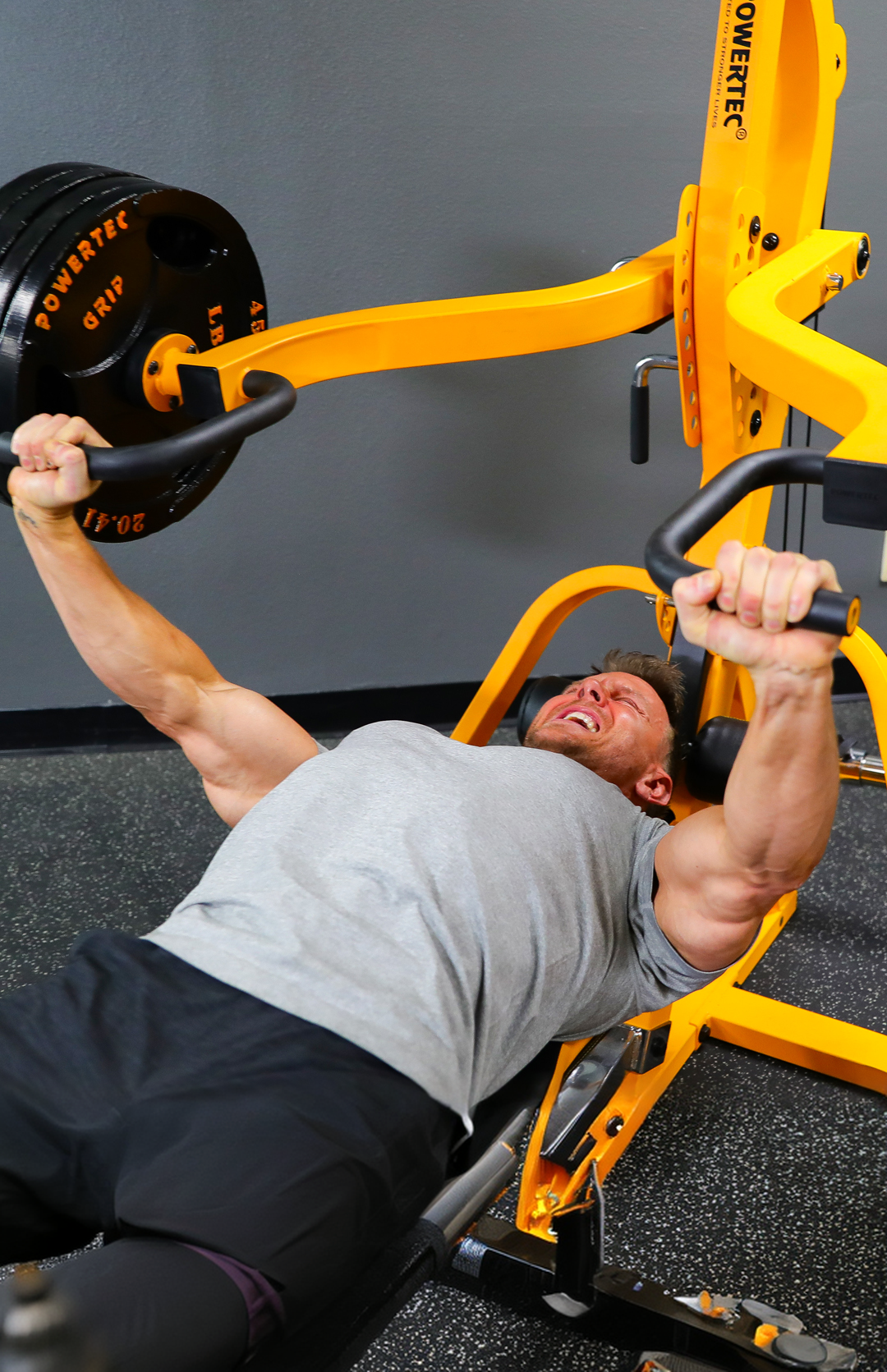 Athlete training with heavy chest press